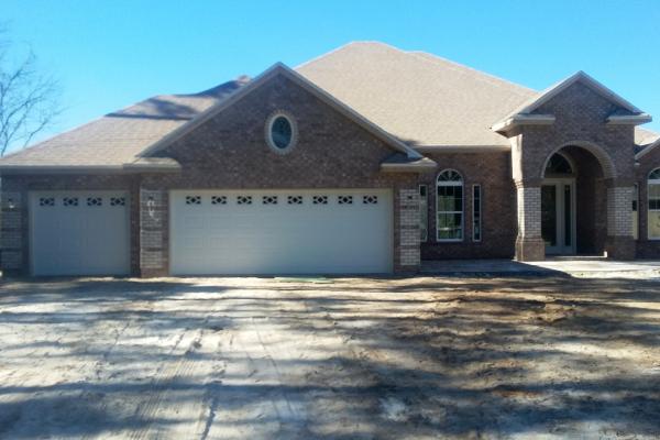 all brick house with white garage door